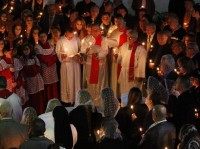 Iraqi Christians pray during a mass on Christmas eve at Sacred Heart Catholic Church in Baghdad