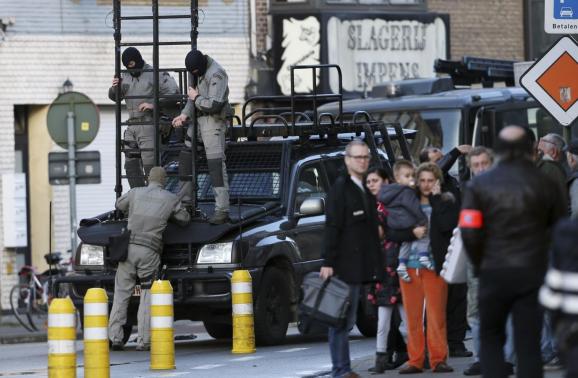Belgian special forces handle a ladder near a building, where four gunmen have taken a man hostage, in Ghent
