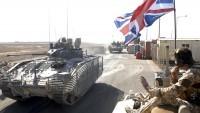 A convoy of British armoured vehicles arrive to contingency operating base after pulling out from Basra Palace, in Basra