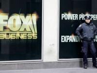 New York City police officers stand guard outside the building that houses Rupert Murdoch's News Corp headquarters in Midtown Manhattan on Friday, Jan. 16, 2015.