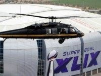 With the Phoenix skyline in the background, a U.S. Customs and Border Protection Black Hawk helicopter flies above University of Phoenix Stadium, site of the NFL Super Bowl XLIX football game, during a security demonstration for the media on Jan. 26.