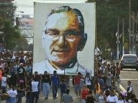 People carry a picture of the late Archbishop Romero during a march ahead of the 34th anniversary of his assassination in San Salvador
