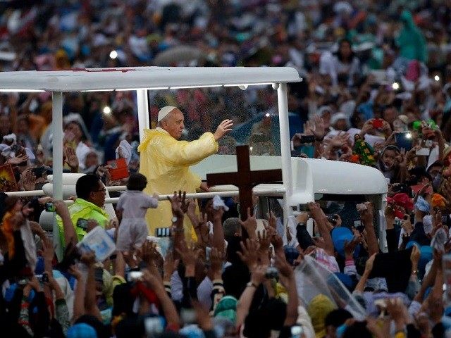 Pope Francis waves from the popemobile after leading a Mass at Rizal Park in Manila