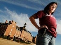 In this photo taken Tuesday, March 1, 2011, Adrienne O'Reilly, Oklahoma Director for Students for Concealed Carry on Campus, carries an empty gun holster on the Oklahoma State University campus in Stillwater, Okla. Some Oklahoma college students will be wearing empty gun holsters to show support for proposed legislation that would allow concealed weapons to be carried on school grounds.