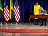 President Barack Obama , accompanied by Jamaican Prime Minister Portia Simpson-Miller, signs the guest book prior to their bilateral meeting at the Jamaica House, April 9, 2015, in Kingston, Jamaica.