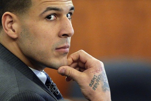 Former New England Patriots football player Aaron Hernandez listens as prosecution witness Alexander Bradley testifies at Bristol County Superior Court in Fall River