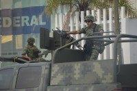 Mexican soldiers guard the Federal Police building in Matamoros following a grenade attack by cartel members.