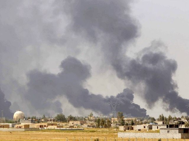 smoke rising above the Baiji area as Iraqi