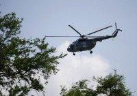 A Mexican Navy helicopter flies overhead during a search for human remains on a river near a new mass grave discovered outside the mountain town of Cocula