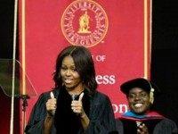 First Lady Michelle Obama gives thumbs up after walking on stage at Tuskegee University, Saturday, May 9, 2015.