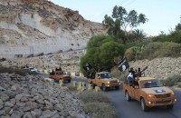 An armed motorcade belonging to members of Derna's Islamic Youth Council, consisting of former members of militias from the town of Derna, drive along a road in Derna, eastern Libya