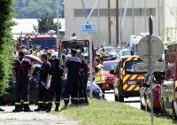 French police and firefighters gather at the entrance of the Air Products company. AFP PHOTO/PHILIPPE DESMAZES
