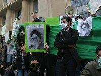 Iranian opposition supporters hold pictu