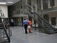 A guard escorts an immigrant detainee from his 'segregation cell' back into the general population at the Adelanto Detention Facility on November 15, 2013 in Adelanto, California. Most detainees in segregation cells are sent there for fighting with other immigrants, according to guards. The facility, the largest and newest Immigration and Customs Enforcement (ICE), detention center in California, houses an average of 1,100 immigrants in custody pending a decision in their immigration cases or awaiting deportation. The average stay for a detainee is 29 days. The facility is managed by the private GEO Group. ICE detains an average of 33,000 undocumented immigrants in more than 400 facilities nationwide.