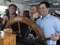 Wisconsin Gov. Scott Walker (right) takes the wheel with former Virginia Gov. Jim Gilmore (center) and former Maryland Gov. Bob Ehrlich at an event Friday on New Hampshire’s Lake Winnipesaukee.