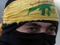 A Palestinian protestor wearing a head banner affiliated with the Shiite Hezbollah movement is seen during clashes between students of the Bir Zeit University and Israeli soldiers in the West Bank village of Betunia following a protest against the killing of three young Palestinian activists the previous day near Yatta on November 27, 2013.