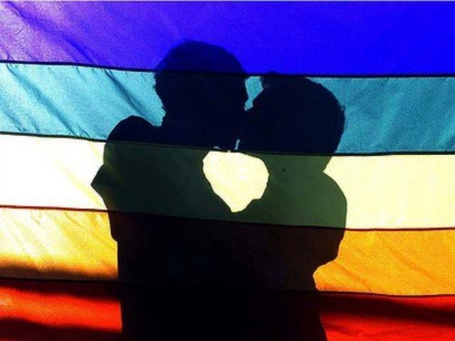 men-kiss-behind-lgbt-rainbow-flag-Reuters-640x480.jpg