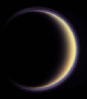 Saturn's moon Titan and Earth host similar polar winds
