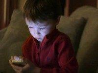 Jameson Young, 4, left, plays with a smart phone as his brother Nolan, 3, looks on at their home, in Boston, Monday, Jan. 27, 2014. Child development experts say it’s natural for toddlers to be fascinated with their own image, and that interest plays an important developmental role as they develop a sense of self.