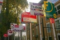 Property sale boards are pictured in For