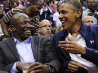 U.S. President Barack Obama shares a laugh with former White House aide Reggie Love as they watch the US Senior Men's National Team and Brazil play during a pre-Olympic exhibition basketball game at the Verizon Center on July 16, 2012 in Washington, DC. (Photo by