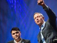 Former Gov. Martin O'Malley (D-MD) (R) speaks of his commitments at the Netroots Nation 2015 Presidential Town Hall with moderator Jose Antonio Vargas at the Phoenix Convention Center July 18, 2015 in Phoenix, Arizona. The Democratic presidential candidate spoke of the criminal justice system in income inequality before being interrupted by demonstrators yelling 'Black Lives Matter' and challenging his record as mayor and governor.