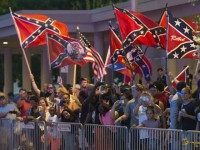 People wave Confederate Flags as US President Barack Obama arrives at his hotel in Oklahoma City, Oklahoma, July 15, 2015.