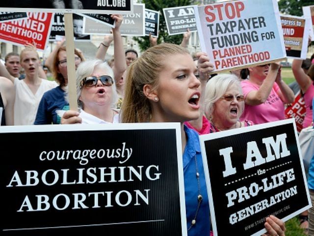 Anti-abortion activists hold a rally opposing federal funding for Planned Parenthood in front of the U.S. Capitol July 28, 2015 in Washington, DC.