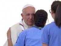 A girl scout kisses Pope Francis at the end of an audience to the Italian Catholics Scouts (Agesci) at St Peter's square on June 13, 2015 at the Vatican.