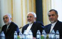 Iranian Foreign Minister Mohammad Javad Zarif and the Head of the Iranian Atomic Energy Organization Ali Akbar Salehi (L) meet with U.S. Secretary of State John Kerry (not pictured) at a hotel in Vienna, Austria