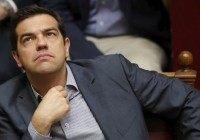 Greek Prime Minister Alexis Tsipras reacts during a voting session at the Parliament in Athens