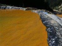 Water flows through a series of sediment retention ponds built to reduce heavy metal and chemical contaminants from the Gold King Mine wastewater accident, in the spillway about 1/4 mile downstream from the mine, outside Silverton, Colo., Friday, Aug. 14, 2015. Officials have said that federal contractors accidentally released more than 3 million gallons of wastewater laden with heavy metals last week at the Gold King Mine near Silverton. The pollution flowed downstream to New Mexico and Utah.