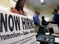 FILE - In this Thursday, Oct. 25, 2012, file photo, a sign attracts job-seekers during a job fair at the Marriott Hotel in Colonie, N.Y. The Labor Department reports on state unemployment rates for July 2015 on Friday, Aug. 21, 2015. (AP Photo/Mike Groll, File)