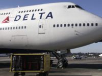 FILE - In this Oct. 9, 2012 file photo, Delta Air Lines 747-400 airplane sits parked at Seattle-Tacoma International Airport in Seattle. Delta Airlines on Monday, Aug. 3, 2015 said that it would no longer accept lion, leopard, elephant, rhinoceros and buffalo hunting trophies. (AP Photo/Ted S. Warren, File)