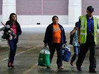 In this July 7, 2015, file photo, immigrants from El Salvador and Guatemala who entered the country illegally board a bus after they were released from a family detention center in San Antonio. Justice Department lawyers are asking a federal judge to reconsider her July ruling ordering the release of children and mothers detained after they entered the U.S. illegally across the Mexican border. File