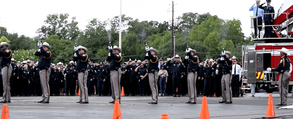 Harris County Sheriff's Honor Guard fires a 21-gun salute.