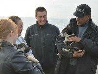 US President Barack Obama holds a puppy beloing to musher John Baker (C) in Kotzebue, Alaska on September 2, 2015. AFP PHOTO/MANDEL NGAN (Photo credit should read