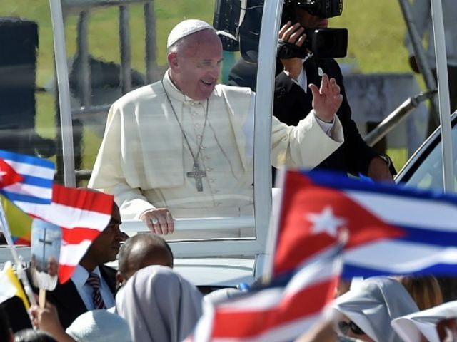 Pope Francis waves at the crowd as he arrives to give a morning mass at the Calixto Garcia square in Holguin, in eastern Cuba, on September 21, 2015. Holguin, a cradle of Catholic faith on the island and also the home region of communist leaders Fidel and Raul Castro, is the only stop on the pope's eight-day, six-city tour of Cuba and the United States that has never received a papal visit. AFP PHOTO / RODRIGO ARANGUA (Photo credit should read