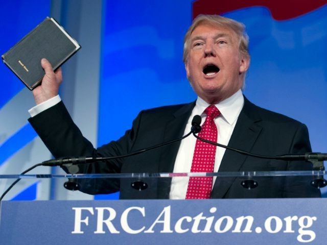 Donald Trump holds up his Bible while speaking at the Values Voter Summit in Washington on Sept. 25, 2015.