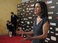 Filmmaker Alexandra Pelosi is interviewed while her husband Michiel Vos and sons Paul Vos and Thomas Vos stand in the background during the New York premiere of the HBO documentary Fall to Grace at Time Warner Center Screening Room on March 21, 2013 in New York City.