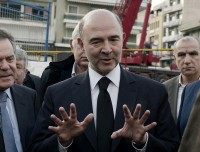 EU Economic Affairs Commissioner Pierre Moscovici (C) talks with Michalis Chryssohoidis, Greek Minister for Infrastructure and Transport, and the President of the Athens Metro, Mr. Christos Tsitouras (L) during their visit to the under construction Korydallos metro station, west of Athens on December 15, 2014. Moscovici is in Athens on a two-day visit ahead of the first round of a snap presidential election that will determine whether Greece will be forced to hold early elections.