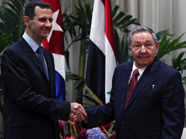 Syrian President Bashar Al Assad (L) and