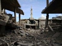 A picture taken on September 30, 2015 shows damaged buildings and a minaret in the central Syrian town of Talbisseh in the Homs province.