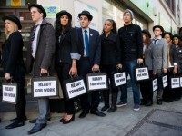 British musicians Miss Dynamite (5th L) and Charlie Simpson (6th L) join unemployed young people as they stand in line outside a job centre in central London during a photocall for the Battlefront Campaign, raising awareness of the large number of young people who are currently unemployed in the UK on October 10, 2011.