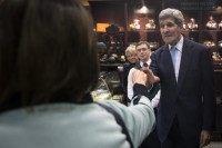 United States Secretary of State John Kerry shakes hands with a woman at  chocolate store Fassbender and Rausch during an unscheduled stop in Berlin,