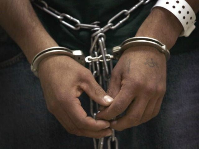 An undocumented immigrant stands cuffed and shackled at the U.S. Immigration and Customs Enforcement (ICE) processing facility before he and other undocumented immigrants were transported to the airport for a deportation flight May 25, 2010 in Broadview, Illinois. The immigrants at the suburban Chicago facility were flown by charter flight to Harlingen, Texas where they were then bussed to Brownsville and finally walked to the Mexican border and released from custody. The U.S. deports over 350,000 immigrants a year for entering the country illegally, most are Mexican, and more than 90 percent are men.