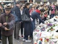 People light candles at a memorial for the victims of the attacks claimed by Islamic State which killed at least 129 people and left more than 350 injured, on November 17, 2015 at the Place de la Republique in Paris. AFP PHOTO / ADRIEN MORLENT