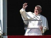Pope Francis addresses the crowd from the window of the apostolic palace overlooking St.Peter's square during his Sunday Angelus prayer for All Saints day, on November 1, 2015 at the Vatican. AFP PHOTO / ALBERTO PIZZOLI (Photo credit should read )