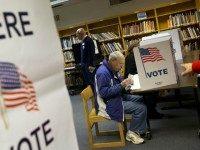 Steve Maskell of McLean, Va., right, votes on election day in McLean, Va., Tuesday, Nov. 5, 2013. ()