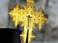 :A member of the Ethiopian church carries a processional crosse as he celebrates 'Meskel', the feast of the Exaltation of the Holy Cross, at the Ethiopian monastery on the roof of the Church of the Holy Sepulchre in Jerusalem's Old City on September 27, 2015. Meskel, Ge'ez word for cross, is an annual celebration that commemorates the finding of the 'True Cross' by the Queen Helena mother of Constantine the Great in the fourth century. AFP PHOTO / GALI TIBBON (Photo credit should read